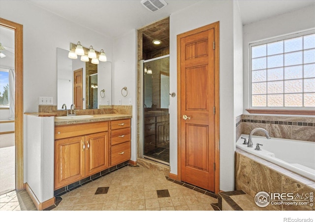 bathroom featuring a stall shower, visible vents, vanity, and a bath