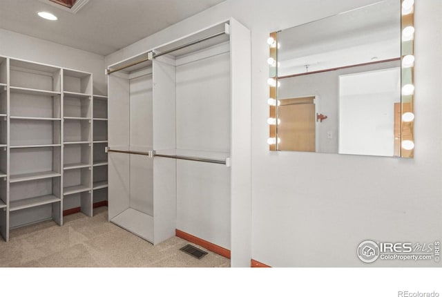 walk in closet with carpet floors and visible vents