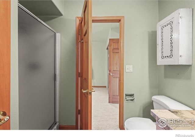 full bathroom with a shower stall and toilet