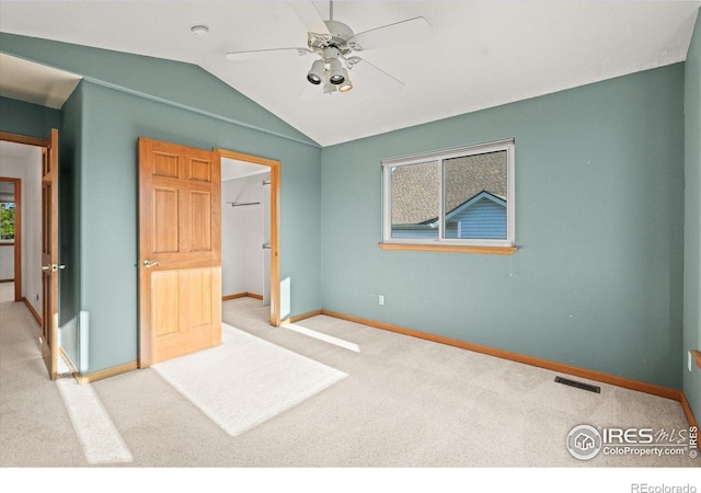 unfurnished bedroom with vaulted ceiling, carpet flooring, visible vents, and baseboards