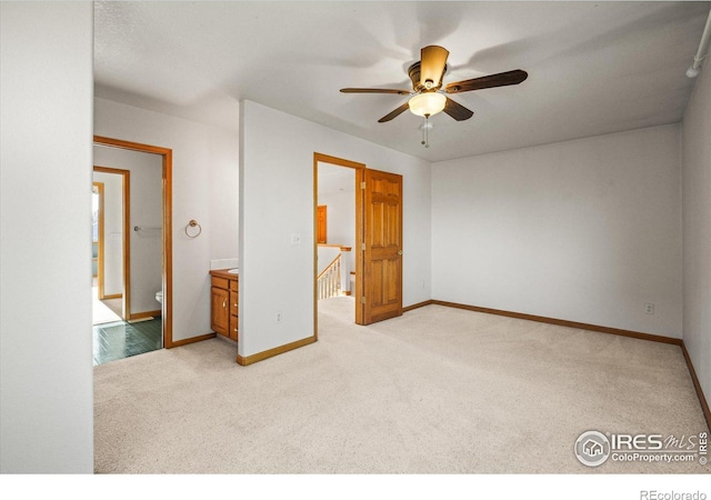 unfurnished bedroom with baseboards, a ceiling fan, and light colored carpet