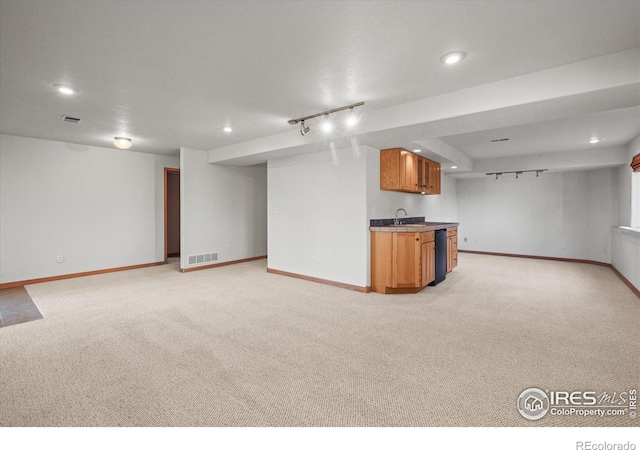 unfurnished living room featuring recessed lighting, light carpet, visible vents, baseboards, and wet bar