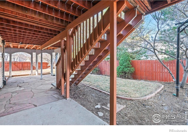 view of patio / terrace featuring stairway and a fenced backyard