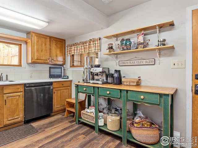 kitchen featuring dark wood finished floors, open shelves, light countertops, a sink, and dishwashing machine