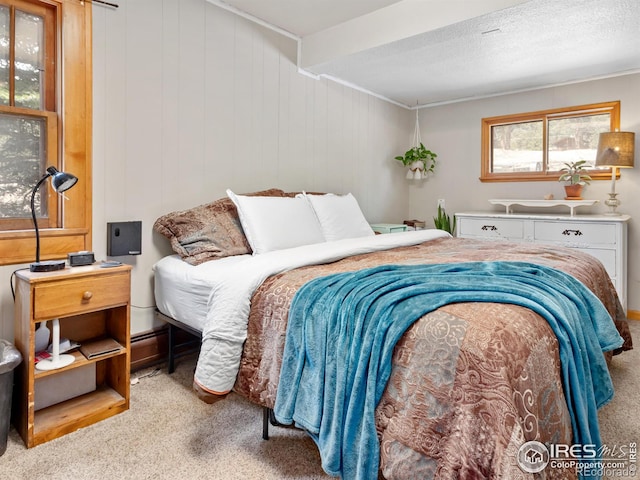 carpeted bedroom featuring a textured ceiling