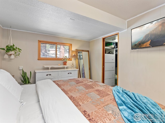 bedroom featuring crown molding and a textured ceiling