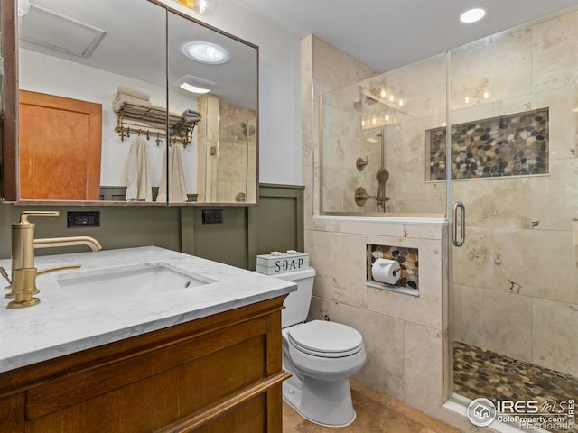 bathroom with toilet, a stall shower, tile patterned flooring, and vanity