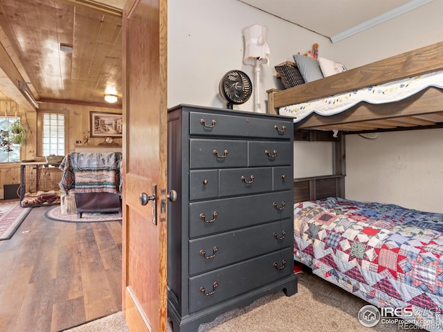 bedroom with ornamental molding, wooden ceiling, and wood finished floors