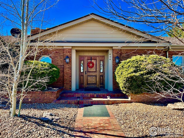 doorway to property with brick siding