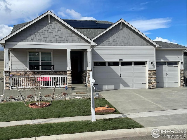 1431 Vantage Pkwy, Berthoud, CO 80513 - craftsman-style home with a garage, covered porch, stone siding, and roof mounted solar panels