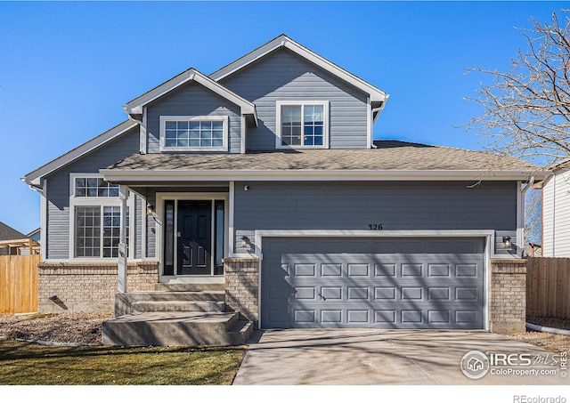 view of front of home featuring fence, concrete driveway, and brick siding