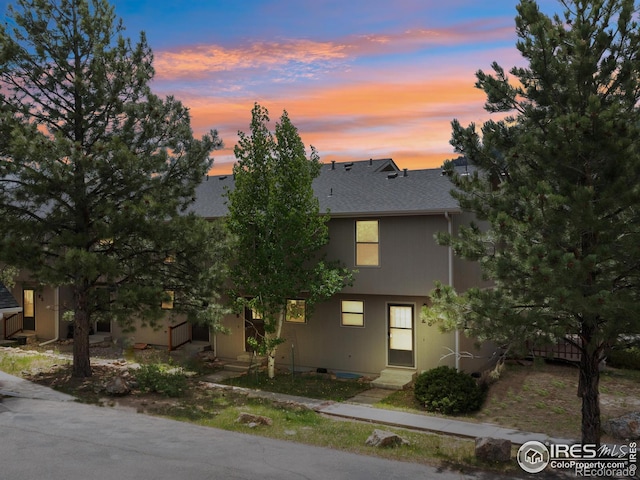 townhome / multi-family property with a shingled roof