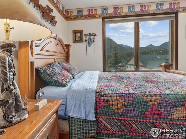 bedroom featuring a mountain view