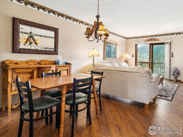 dining area featuring dark wood finished floors and a textured ceiling