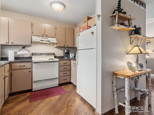 kitchen featuring dark countertops, white appliances, under cabinet range hood, and wood finished floors