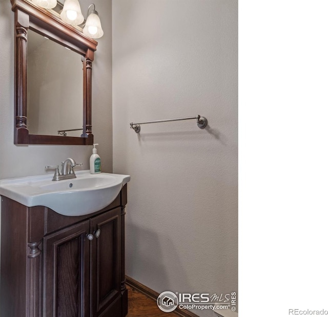 bathroom with baseboards and vanity