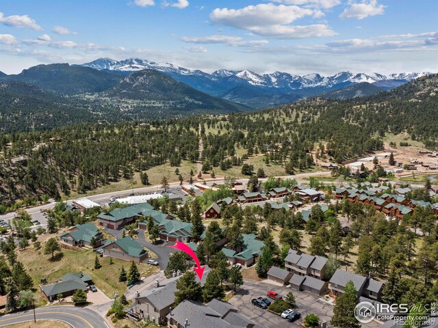 drone / aerial view with a residential view, a mountain view, and a view of trees