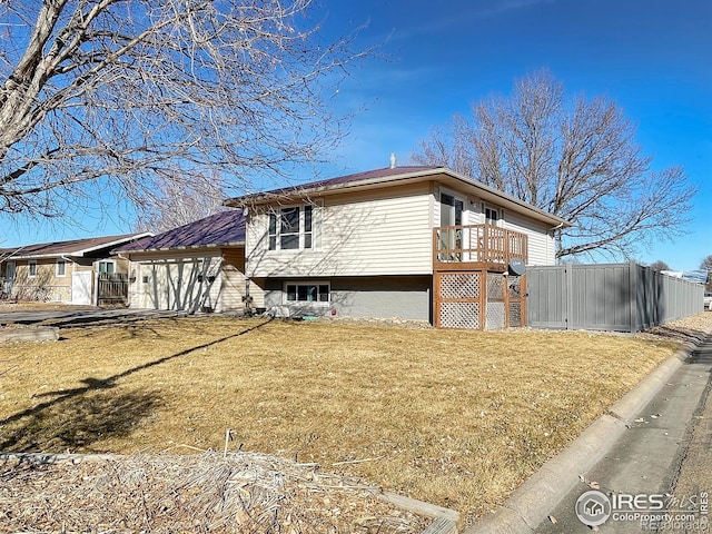 view of side of property with a lawn and fence