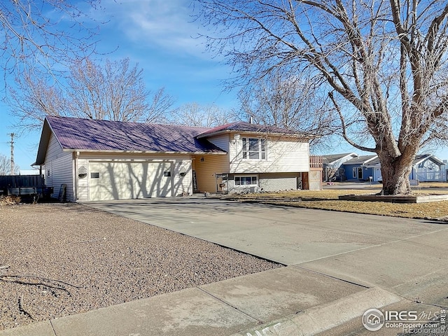 split level home with driveway and an attached garage