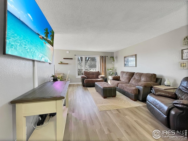 living room featuring a textured ceiling and wood finished floors