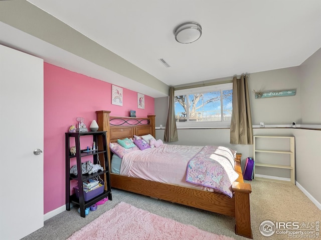 bedroom with baseboards, visible vents, and carpet flooring