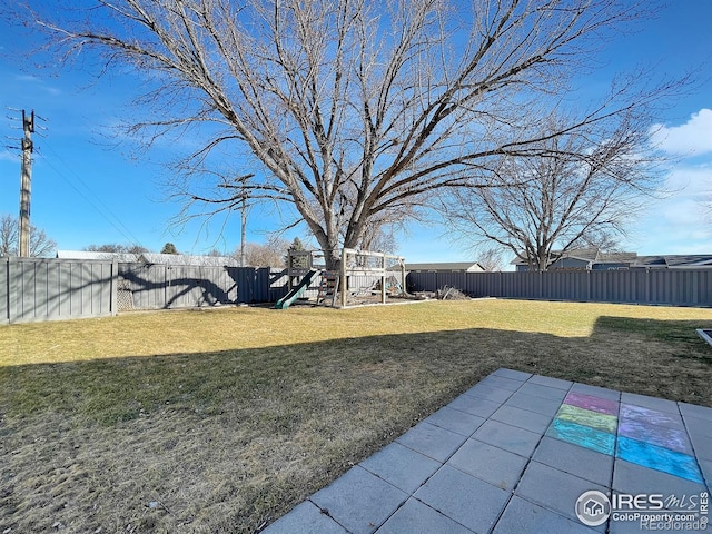 view of yard featuring a fenced backyard and a playground