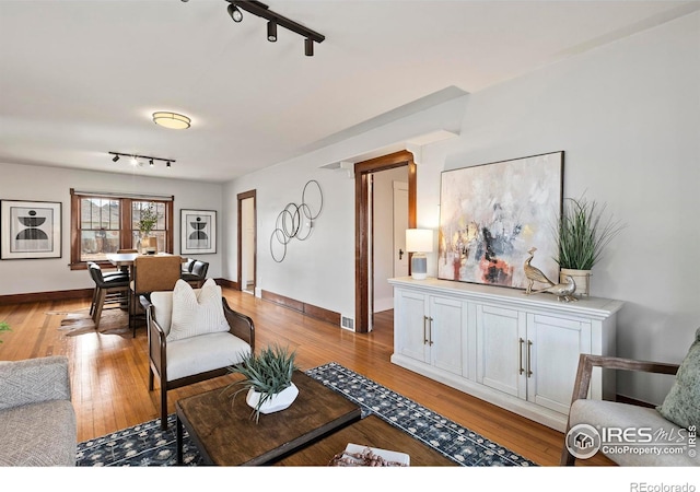 530 Laporte Ave, Fort Collins, CO 80521 - living area featuring light wood-style floors, baseboards, and rail lighting
