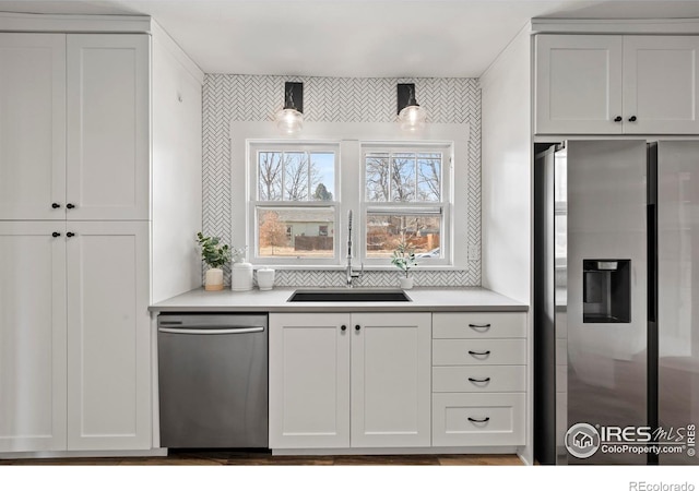530 Laporte Ave, Fort Collins, CO 80521 - kitchen with appliances with stainless steel finishes, a sink, light countertops, and white cabinetry