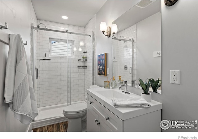 530 Laporte Ave, Fort Collins, CO 80521 - full bath with a shower stall, vanity, visible vents, toilet, and wood finished floors