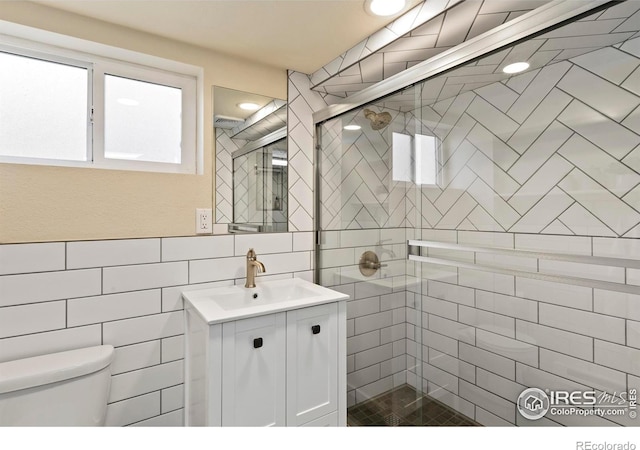530 Laporte Ave, Fort Collins, CO 80521 - bathroom with toilet, a stall shower, vanity, and tile walls
