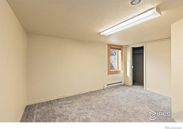 530 Laporte Ave, Fort Collins, CO 80521 - unfurnished bedroom featuring a textured ceiling, a closet, carpet floors, a baseboard heating unit, and baseboards