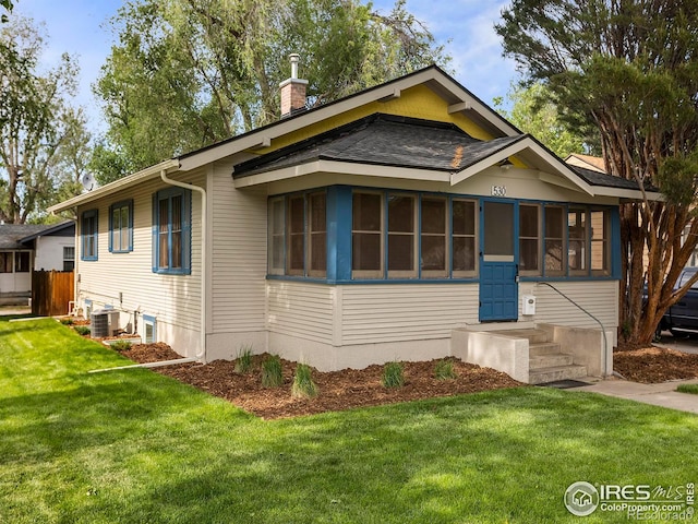 530 Laporte Ave, Fort Collins, CO 80521 - view of front of property with roof with shingles, a front yard, central AC unit, and a chimney