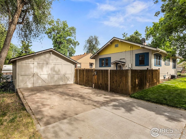 530 Laporte Ave, Fort Collins, CO 80521 - view of front of home featuring an outdoor structure, a front yard, fence, a garage, and central AC unit