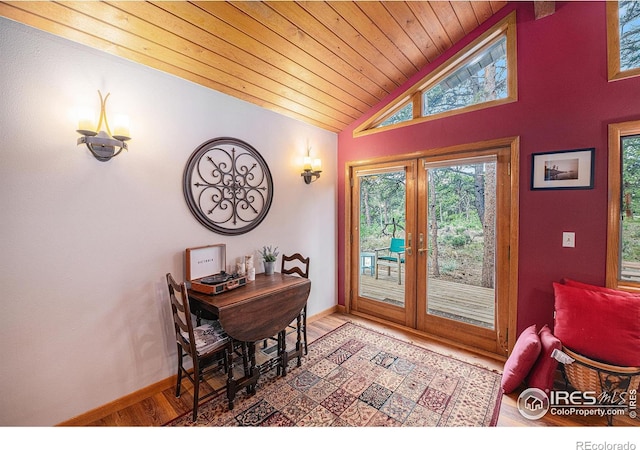 dining room featuring french doors, lofted ceiling, wood finished floors, wooden ceiling, and baseboards