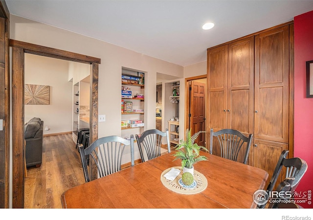 dining room with baseboards and wood finished floors