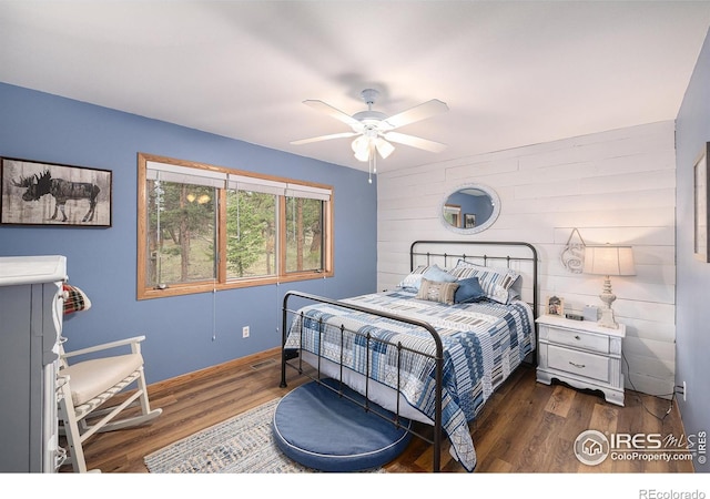 bedroom with visible vents, a ceiling fan, and wood finished floors