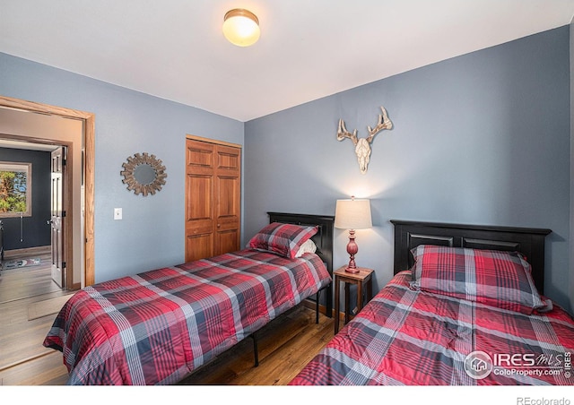 bedroom featuring a closet and wood finished floors