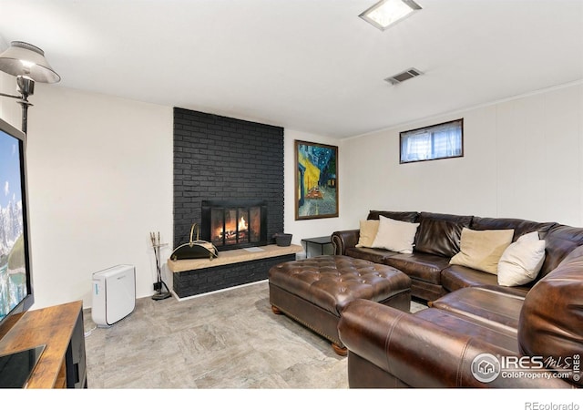 living room with a brick fireplace and visible vents