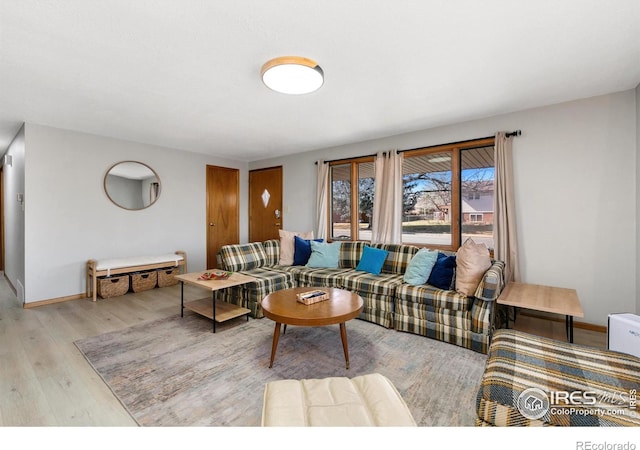 living room with light wood-type flooring and baseboards