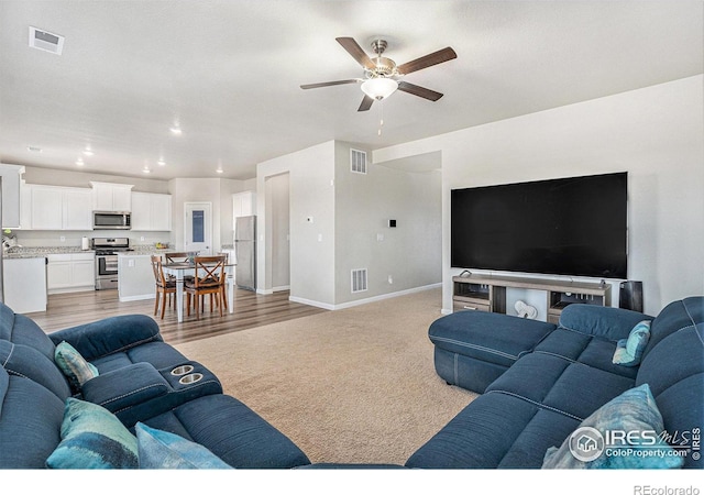 2539 Alto St, Fort Lupton, CO 80621 - living room with a ceiling fan, visible vents, and baseboards
