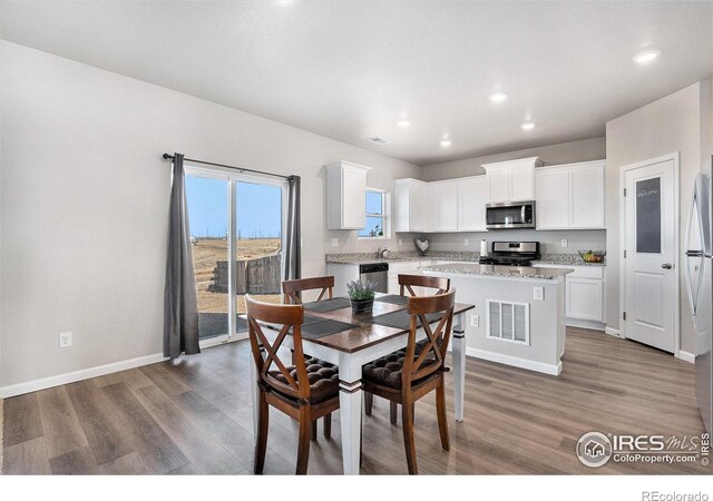 2539 Alto St, Fort Lupton, CO 80621 - dining room featuring recessed lighting, wood finished floors, visible vents, and baseboards