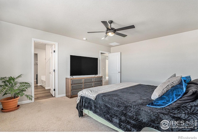 2539 Alto St, Fort Lupton, CO 80621 - carpeted bedroom featuring a ceiling fan, baseboards, a textured ceiling, and ensuite bathroom