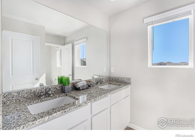 2539 Alto St, Fort Lupton, CO 80621 - full bath with a sink, baseboards, and double vanity