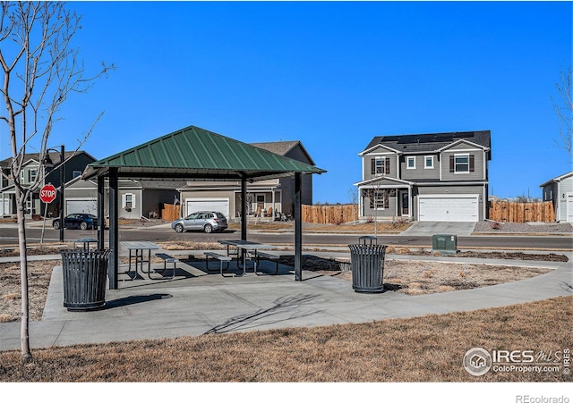 2539 Alto St, Fort Lupton, CO 80621 - view of property's community with an attached garage, fence, and concrete driveway
