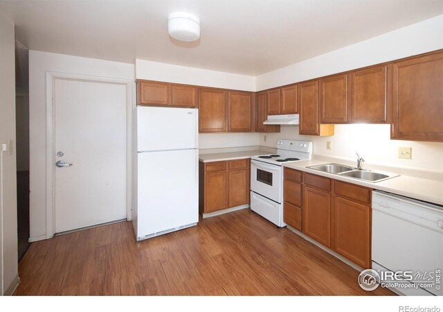 216-218 E Saint Clair Ave, Longmont, CO 80504 - kitchen featuring light wood-style flooring, white appliances, a sink, and under cabinet range hood
