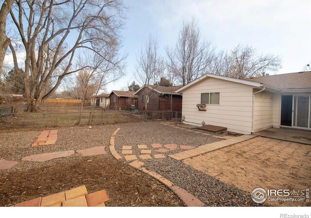 216-218 E Saint Clair Ave, Longmont, CO 80504 - view of yard featuring fence and a patio