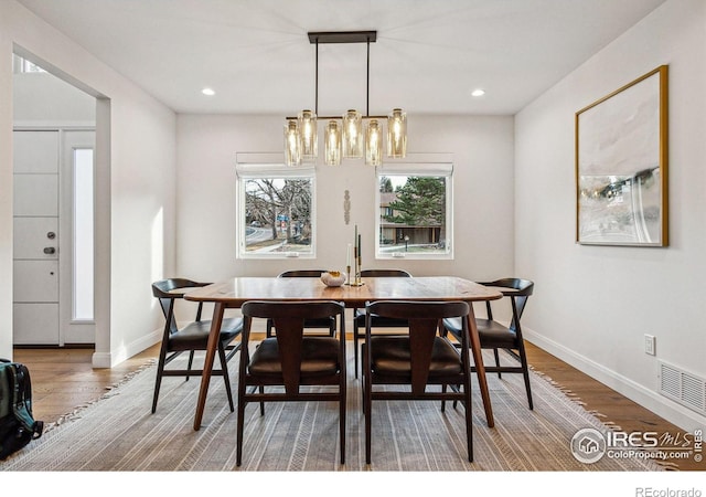 dining room with recessed lighting, visible vents, baseboards, and wood finished floors