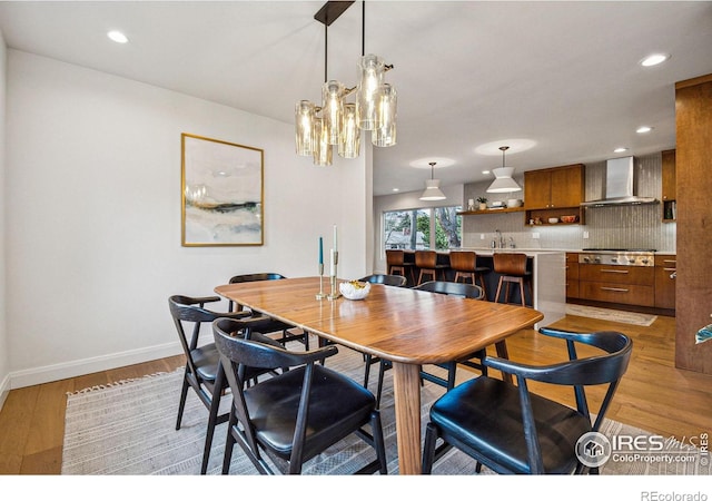 dining area with light wood-style floors, baseboards, and recessed lighting