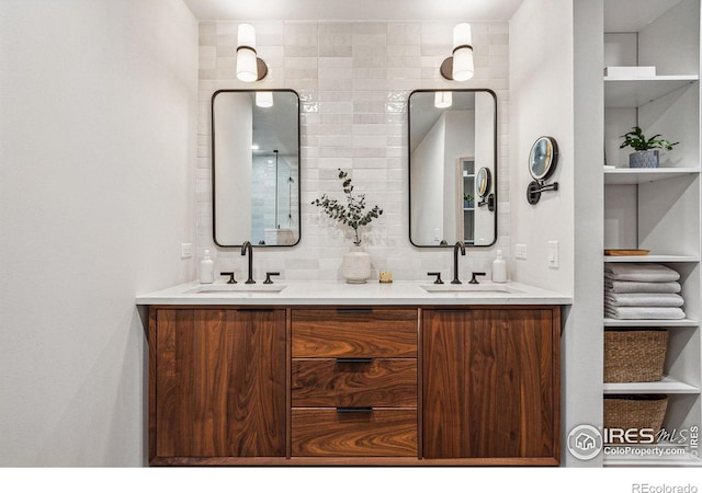 full bath with double vanity, backsplash, and a sink