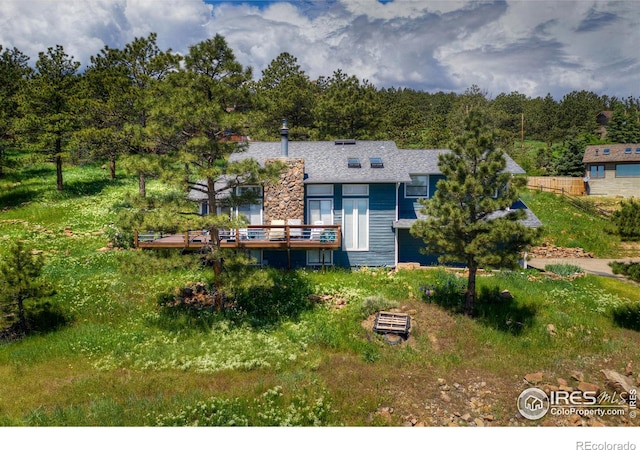 rear view of property featuring a deck